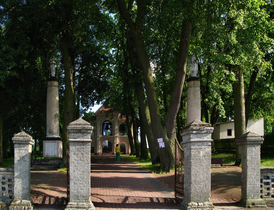 Wooden St Stanislaus church, bell tower and church cemetery in Sarnaki